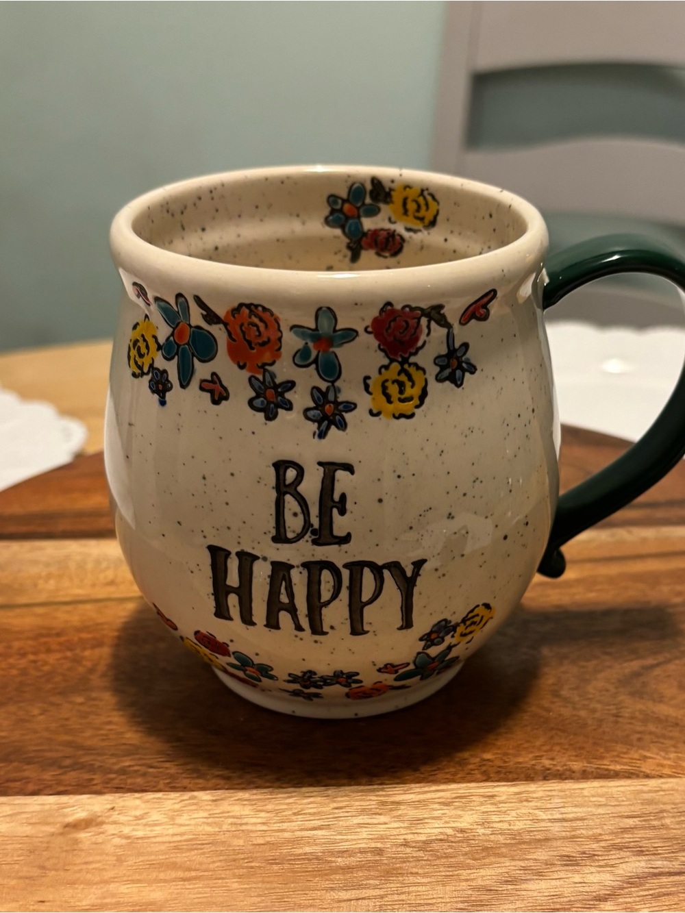 Tag 'Be Happy' Cream Ceramic Mug with Floral Accents and Dark Green Handle